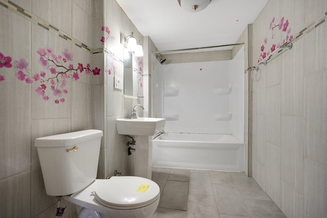 full bath featuring shower / washtub combination, tile patterned flooring, tile walls, and toilet