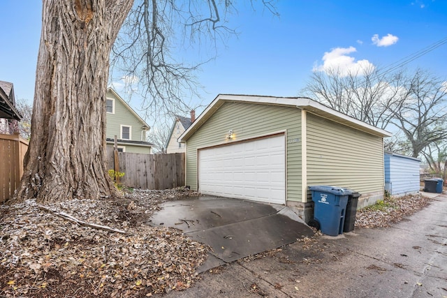 detached garage featuring fence