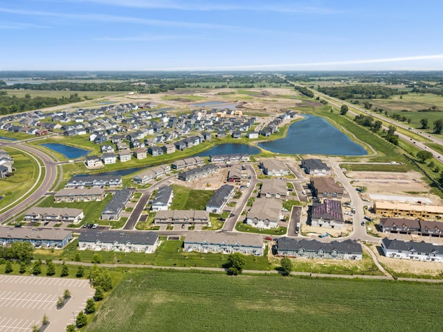 drone / aerial view with a water view and a residential view