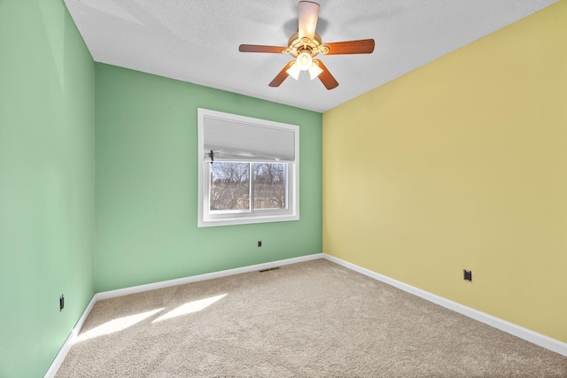 unfurnished room with carpet flooring, baseboards, and ceiling fan