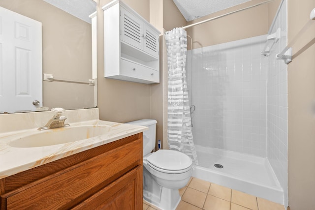 full bath featuring tile patterned floors, a shower stall, a textured ceiling, and toilet