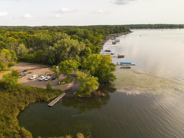 aerial view with a forest view and a water view