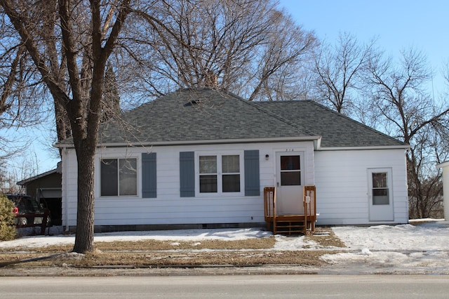 view of front of property with entry steps and roof with shingles