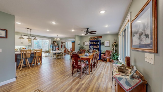 dining room featuring recessed lighting, baseboards, light wood finished floors, and ceiling fan with notable chandelier