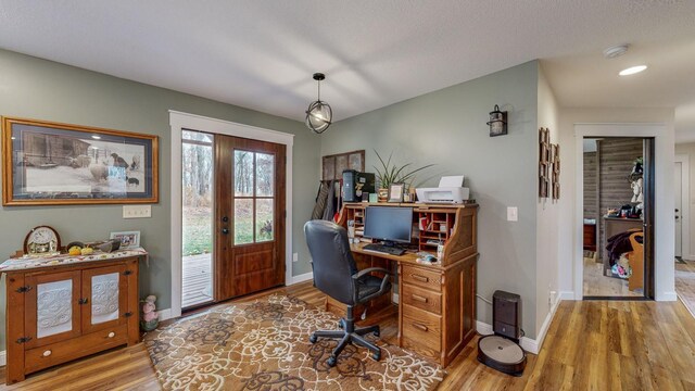 office area featuring baseboards and wood finished floors