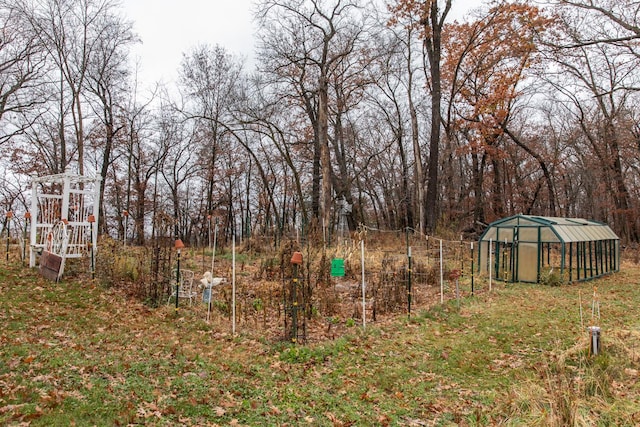 view of yard featuring an exterior structure, an outdoor structure, and fence