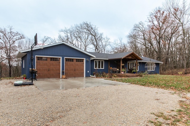 ranch-style house with a garage, driveway, and a porch