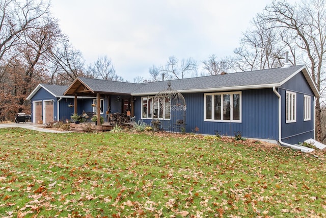 ranch-style home with a garage and a front lawn