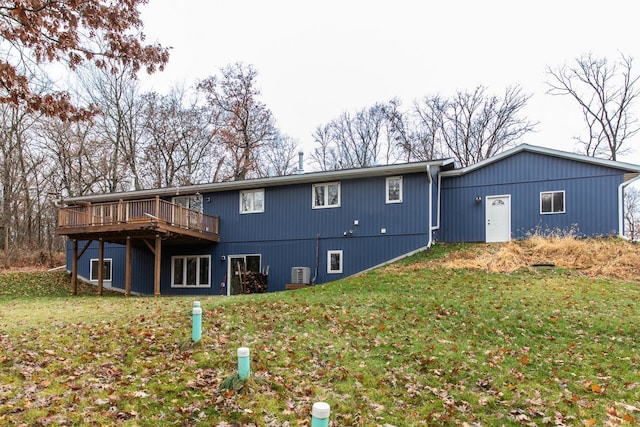 back of property featuring a lawn and a wooden deck