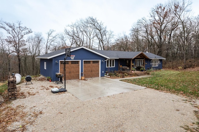 ranch-style house with a garage, concrete driveway, and covered porch