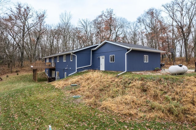 exterior space featuring a deck and a front lawn