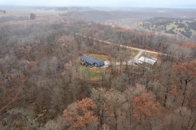 birds eye view of property featuring a rural view and a wooded view