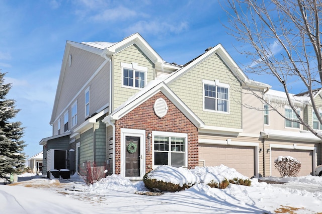 view of front of home with brick siding and an attached garage