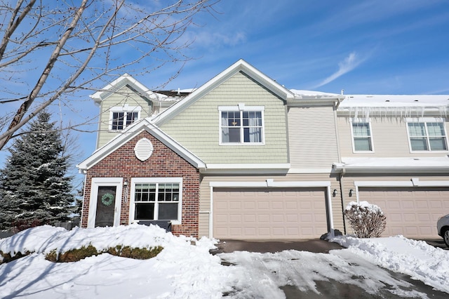 view of front of house featuring a garage and brick siding