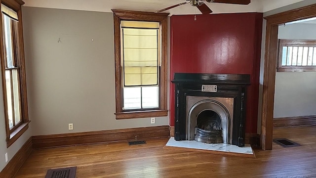 interior space featuring visible vents, a fireplace, and hardwood / wood-style floors