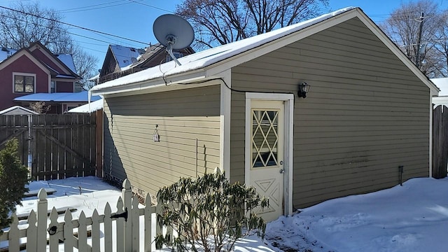 view of snowy exterior with fence