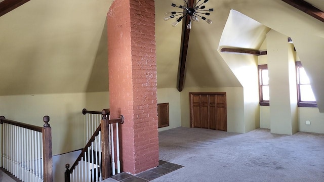 additional living space featuring vaulted ceiling with beams and carpet