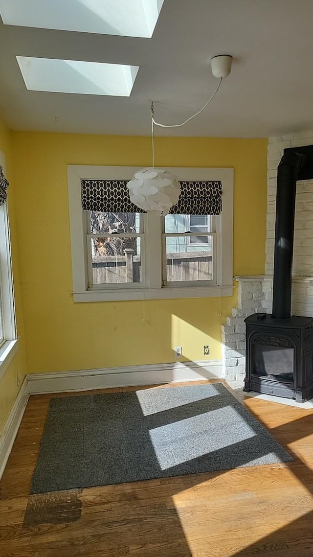 unfurnished living room featuring plenty of natural light and wood finished floors