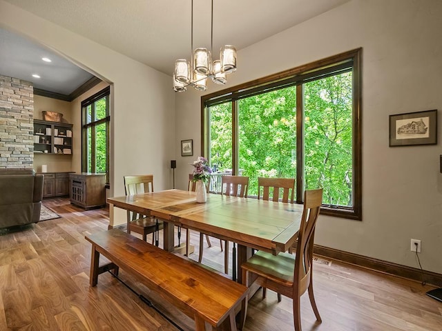 4350 Golfview Dr, Jordan, MN 55352 - dining space featuring light wood-style flooring, a chandelier, baseboards, and crown molding