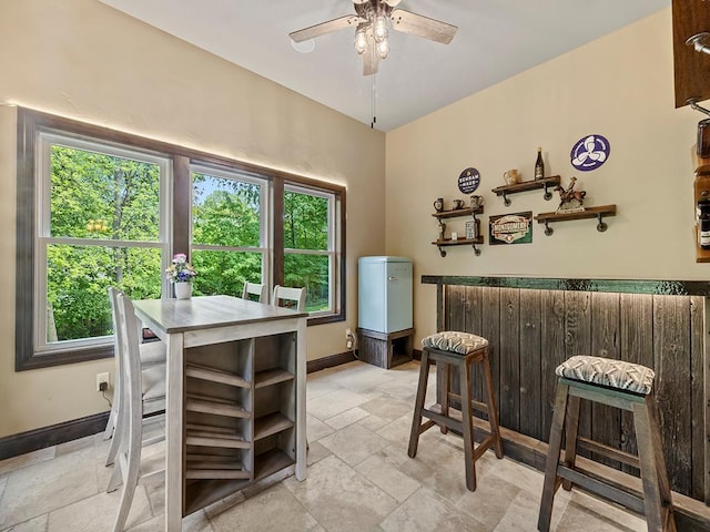 4350 Golfview Dr, Jordan, MN 55352 - dining area featuring a bar, plenty of natural light, stone tile floors, and ceiling fan