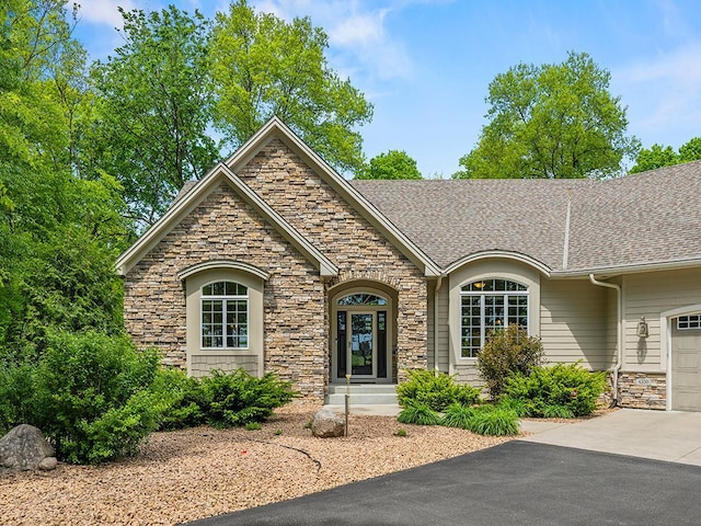 4350 Golfview Dr, Jordan, MN 55352 - craftsman-style home featuring stone siding, driveway, a garage, and a shingled roof