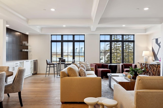 living area featuring light wood-style flooring, recessed lighting, baseboards, ornamental molding, and beamed ceiling