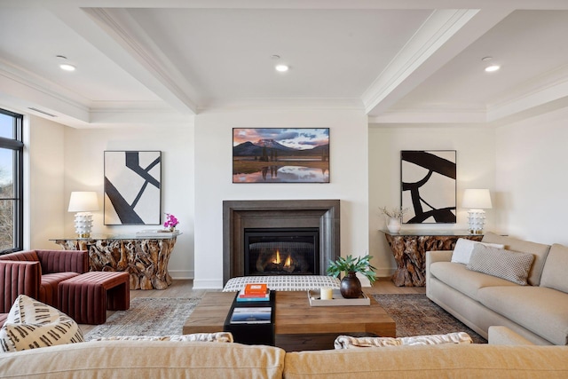 living room featuring ornamental molding, a glass covered fireplace, and wood finished floors