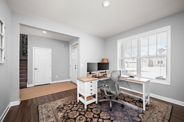 office area featuring a textured ceiling, baseboards, and dark wood-type flooring