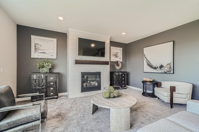 living area featuring carpet floors, a large fireplace, baseboards, and recessed lighting