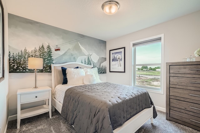 bedroom featuring carpet and baseboards