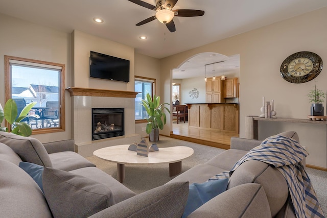 living room featuring baseboards, a ceiling fan, carpet floors, a fireplace, and recessed lighting