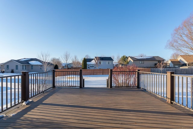 wooden terrace featuring a residential view and fence