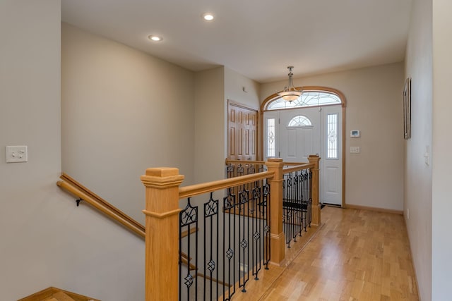 entryway with baseboards, wood finished floors, and recessed lighting