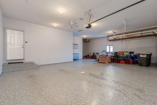 garage with ceiling fan and a garage door opener