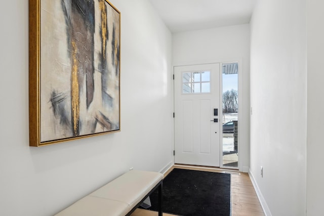 entryway featuring wood finished floors and baseboards