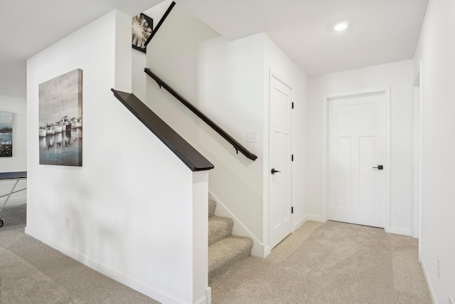 staircase featuring carpet, baseboards, and recessed lighting