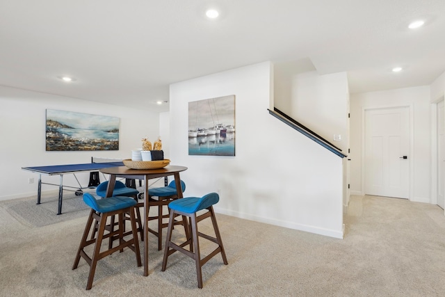 dining space with recessed lighting, baseboards, and light colored carpet