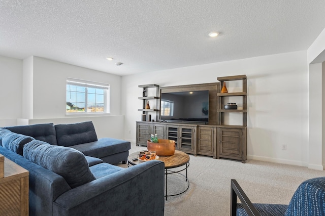 living room featuring carpet flooring, a textured ceiling, and baseboards