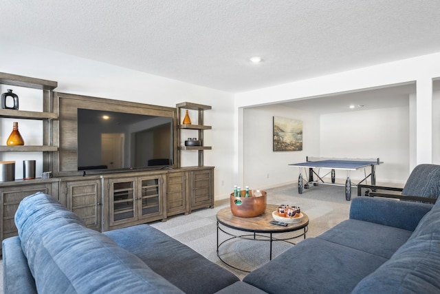 carpeted living room featuring a textured ceiling and baseboards