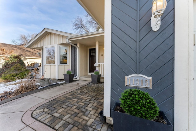 view of exterior entry with board and batten siding