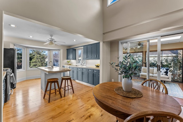 dining room with light wood finished floors, recessed lighting, and a ceiling fan