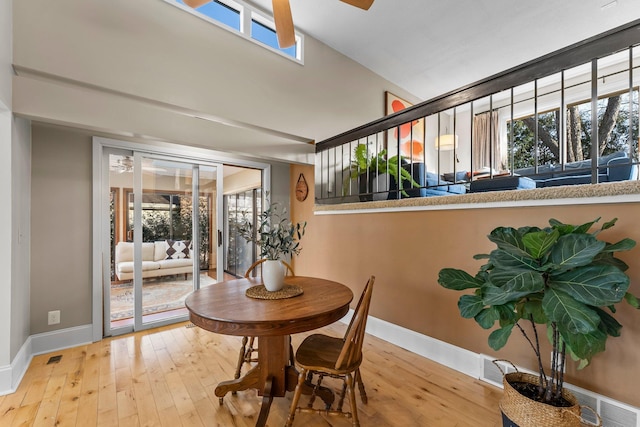 dining room with hardwood / wood-style floors, visible vents, and baseboards