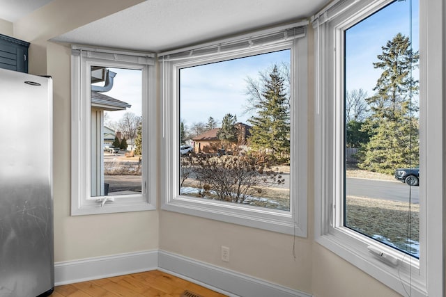 interior space with light wood-style floors and baseboards