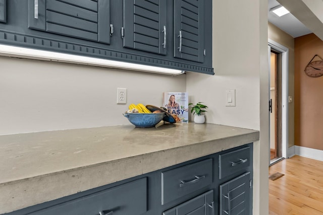 bar with visible vents, baseboards, and light wood-style floors