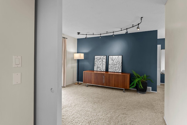 interior space featuring track lighting and baseboards