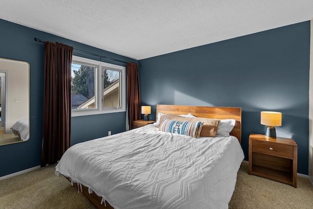 bedroom with a textured ceiling, baseboards, and carpet floors