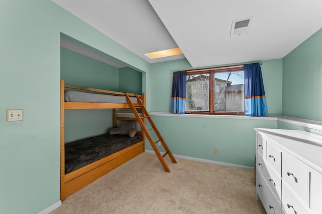 bedroom featuring light colored carpet, visible vents, and baseboards