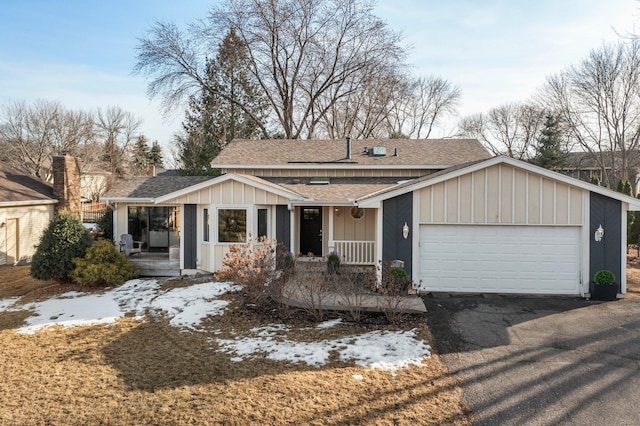 ranch-style house featuring driveway, a shingled roof, a garage, and board and batten siding