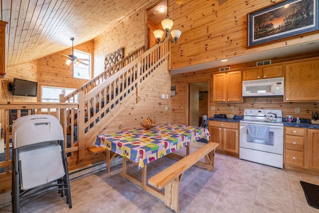 kitchen featuring white appliances, wooden walls, visible vents, dark countertops, and wood ceiling