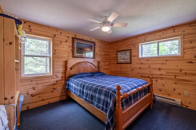 carpeted bedroom featuring a textured ceiling, ceiling fan, and a baseboard radiator